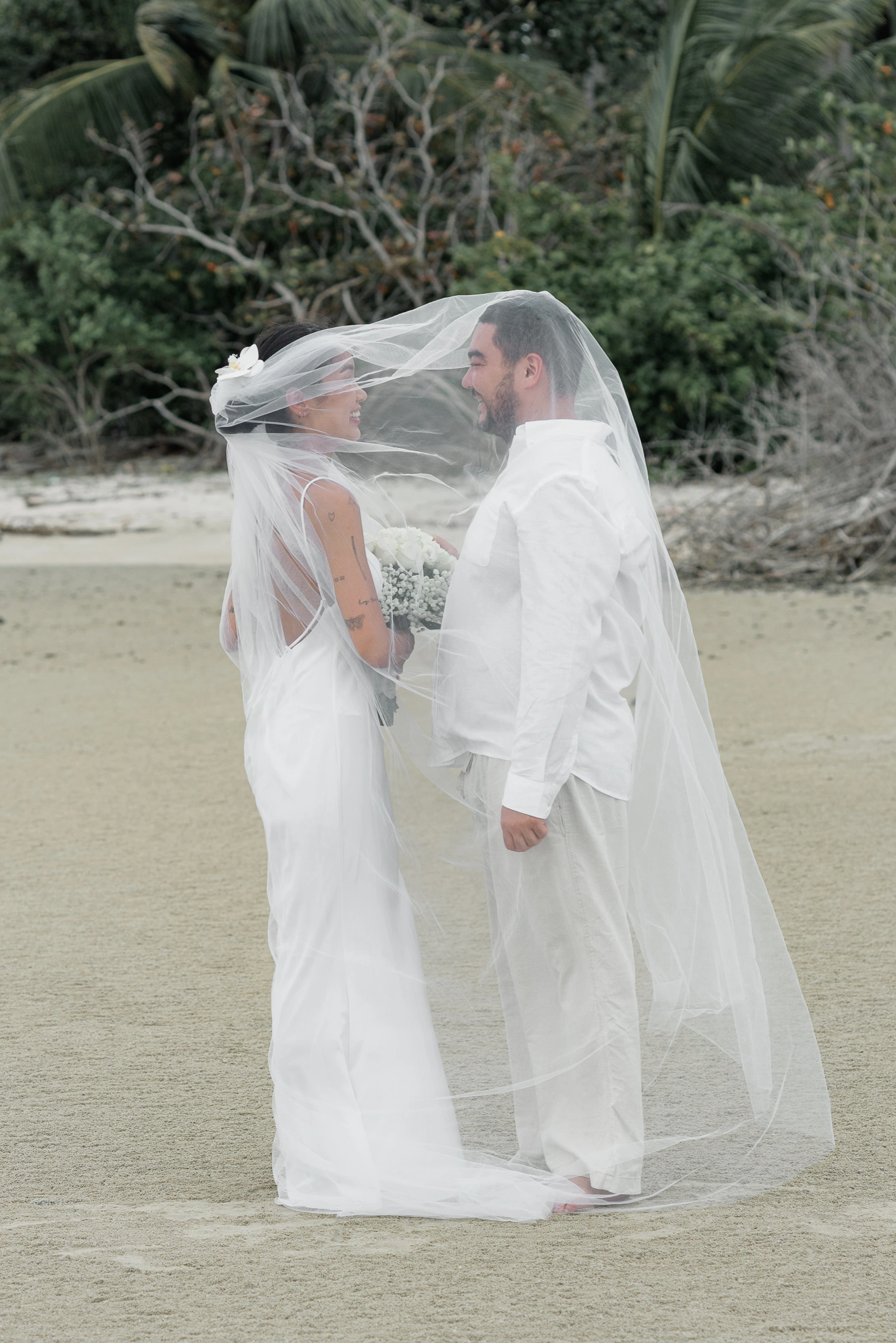 Bride posing in soft light beside the sea