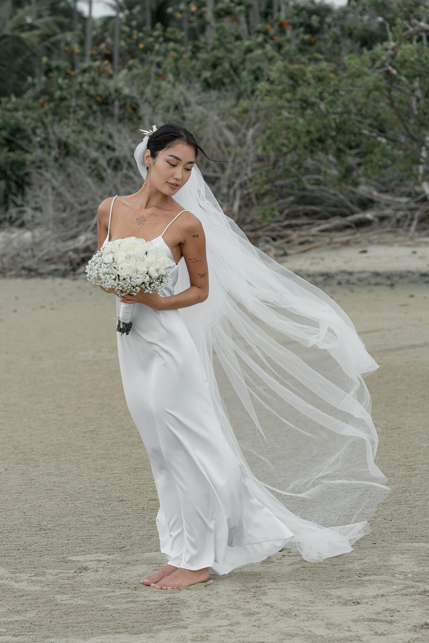 Bride holding her bouquet in a flowing veil