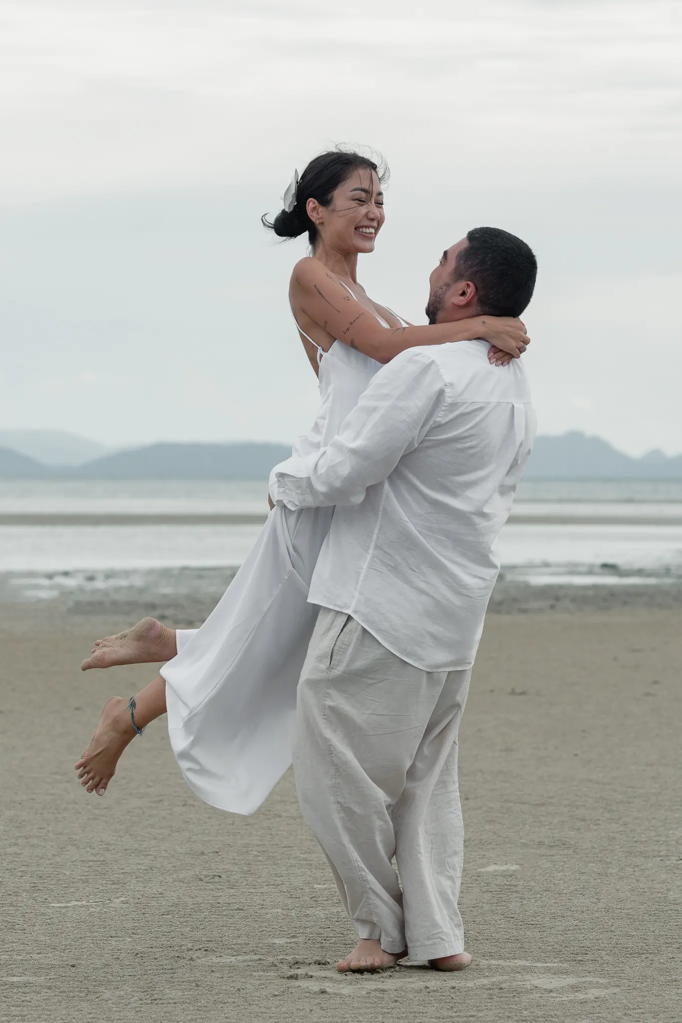 Joyful couple portrait at the beach