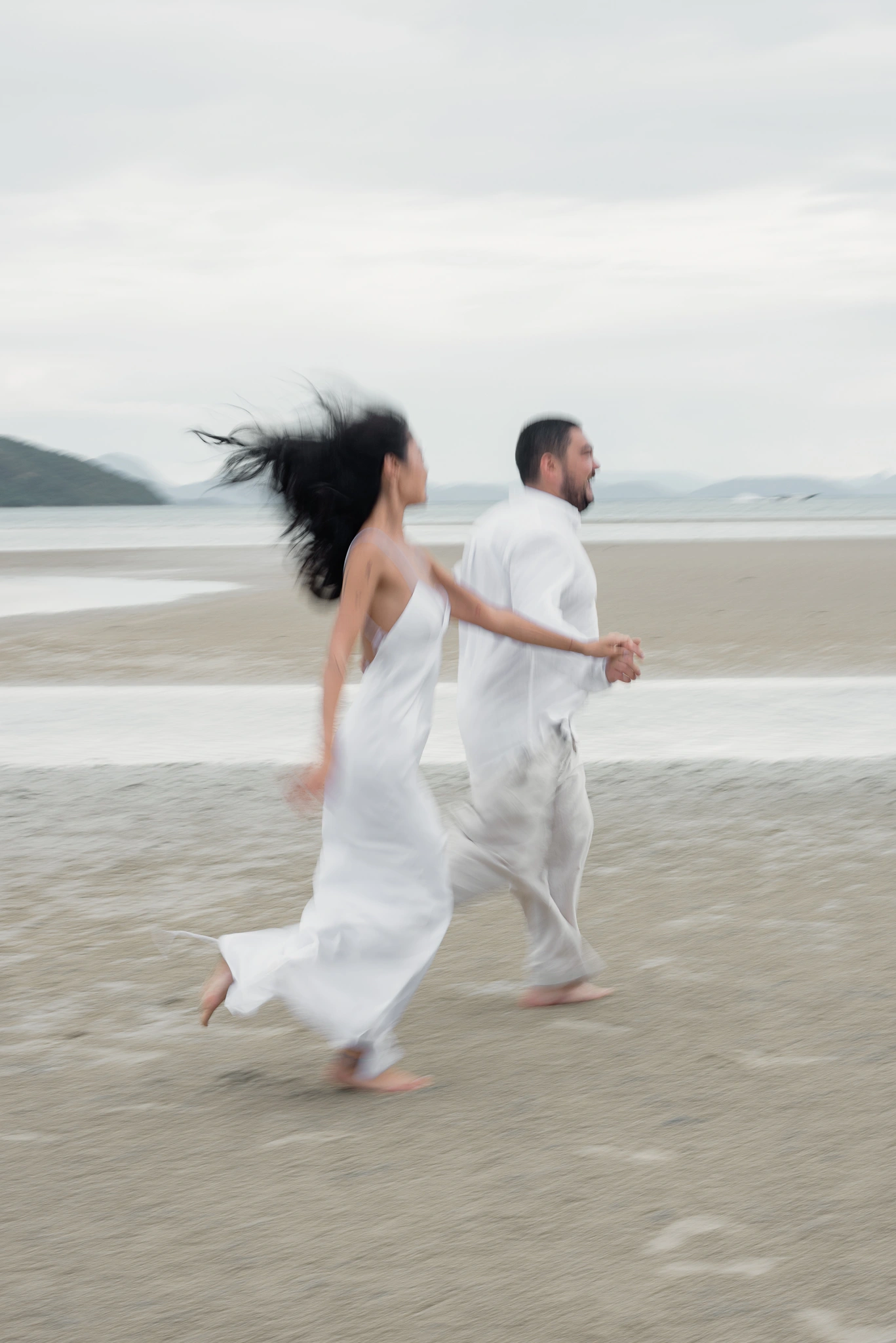Bride and groom running in an intentional motion-blurred portrait