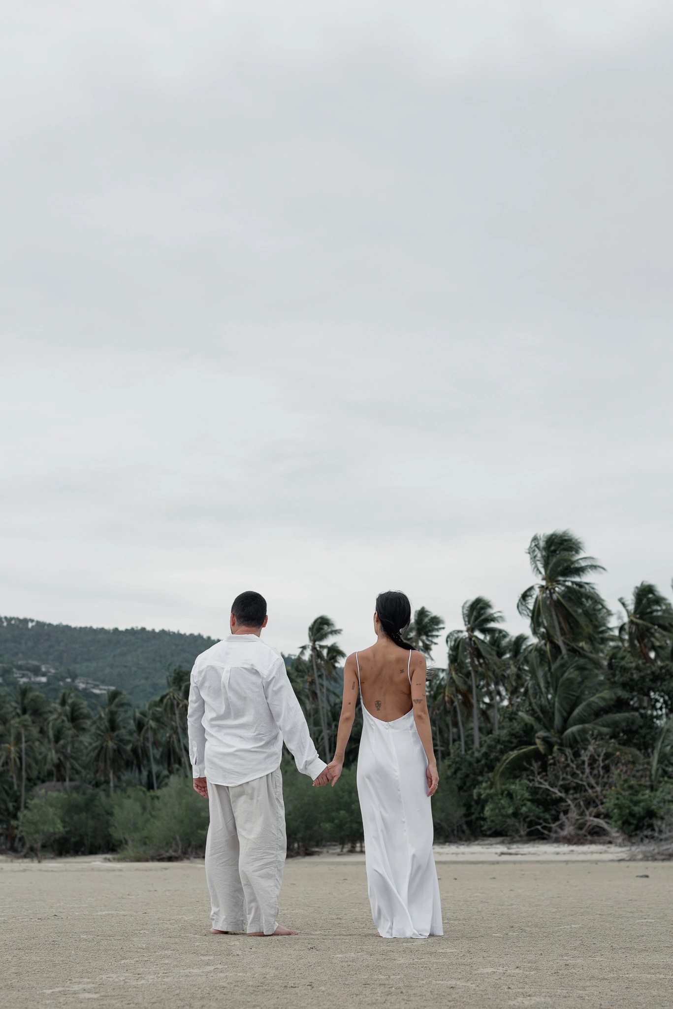 Distant portrait of the couple together on a tropical beach