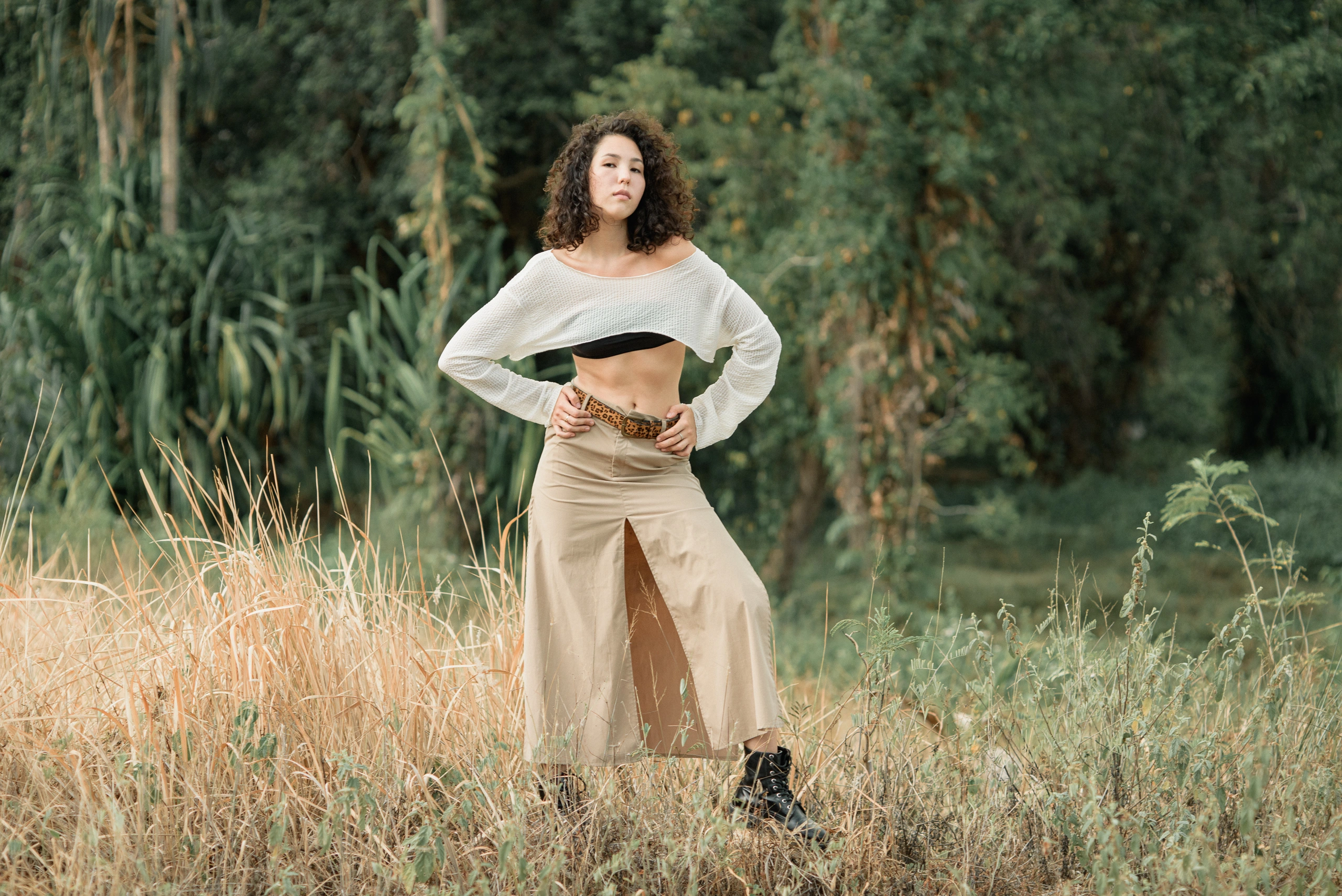 Wide fashion scene in a field of tall grass