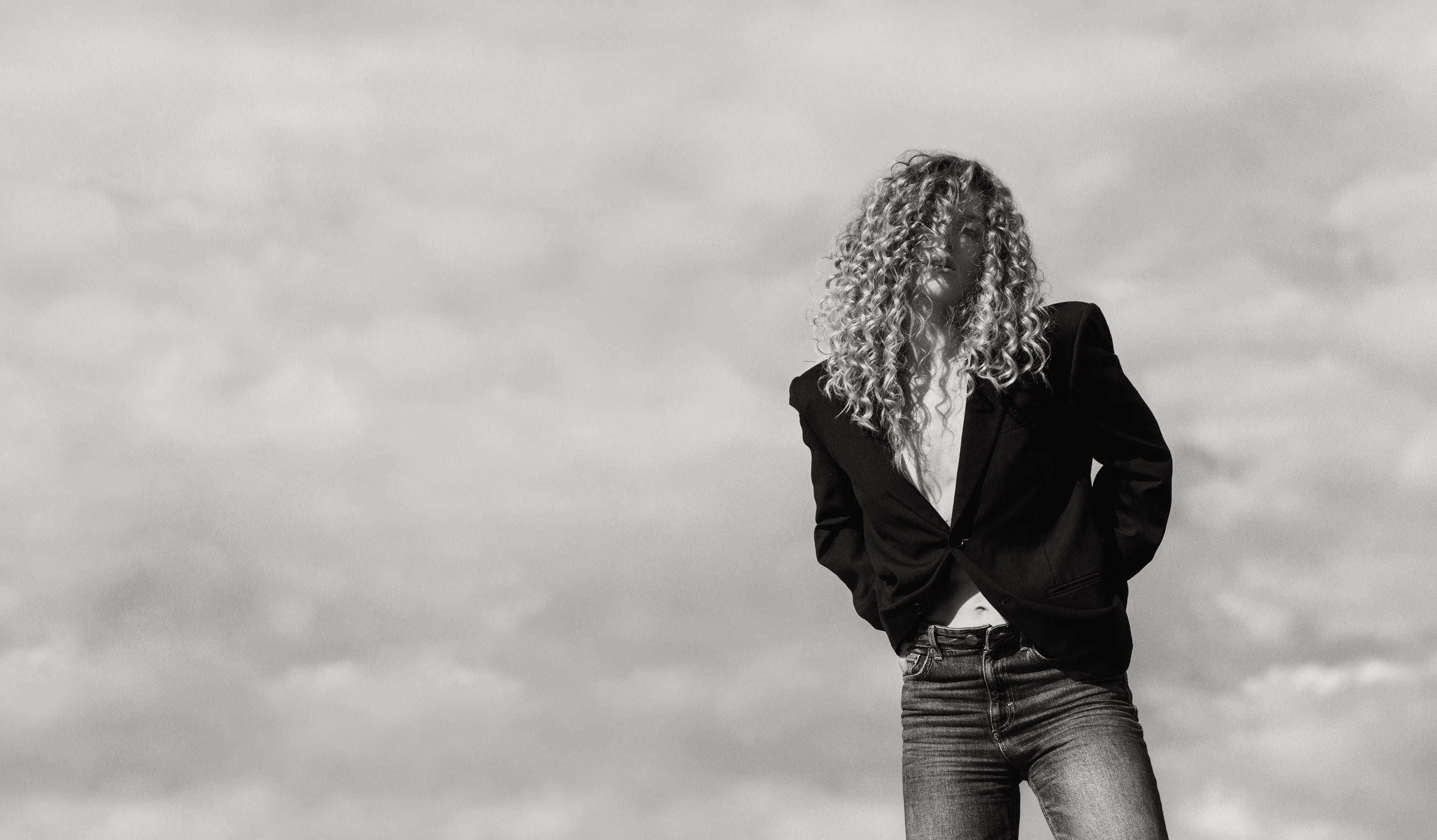 Yana Laskovaya in a black jacket against a cloudy Koh Samui sky