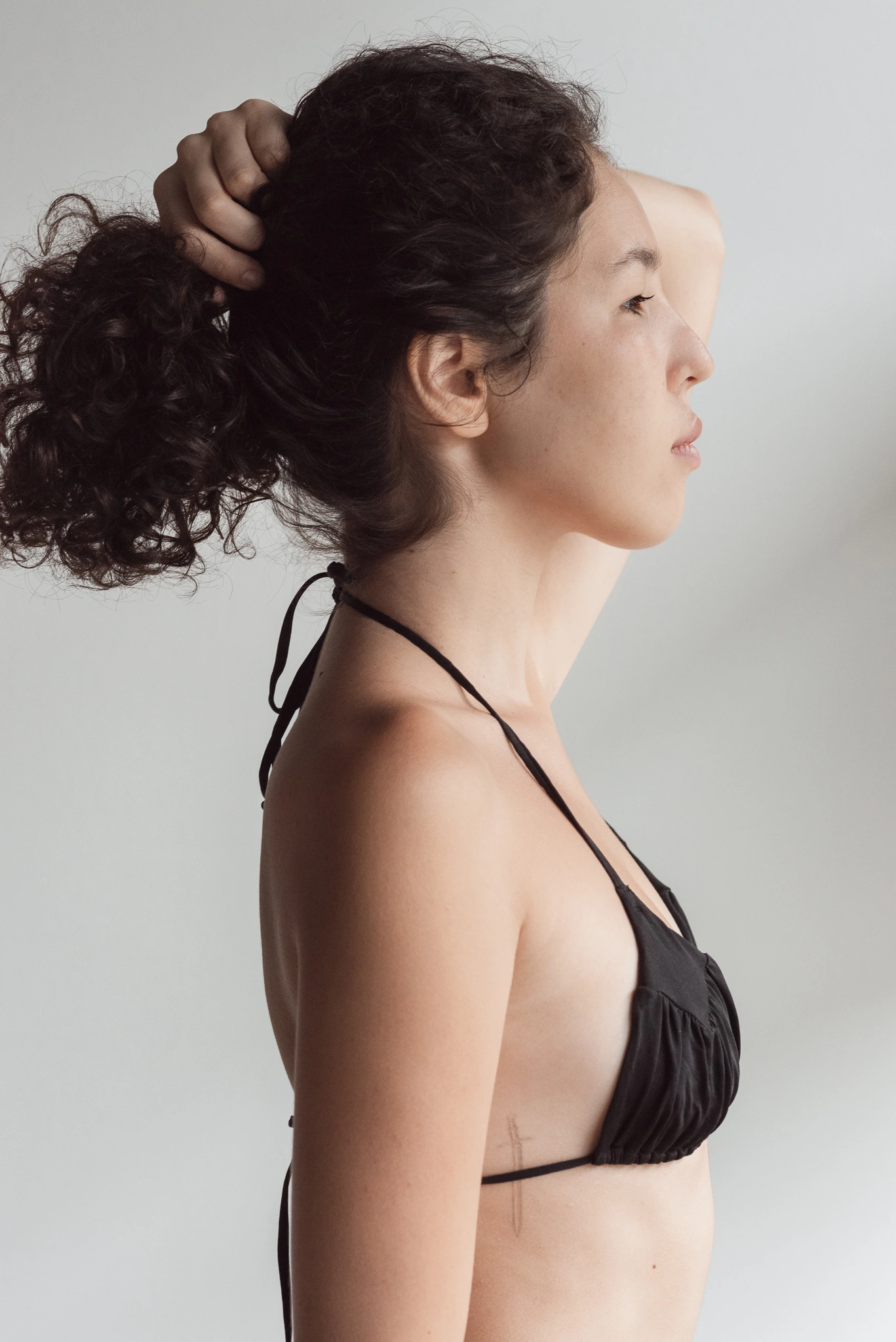 Close profile portrait with sculptural movement
